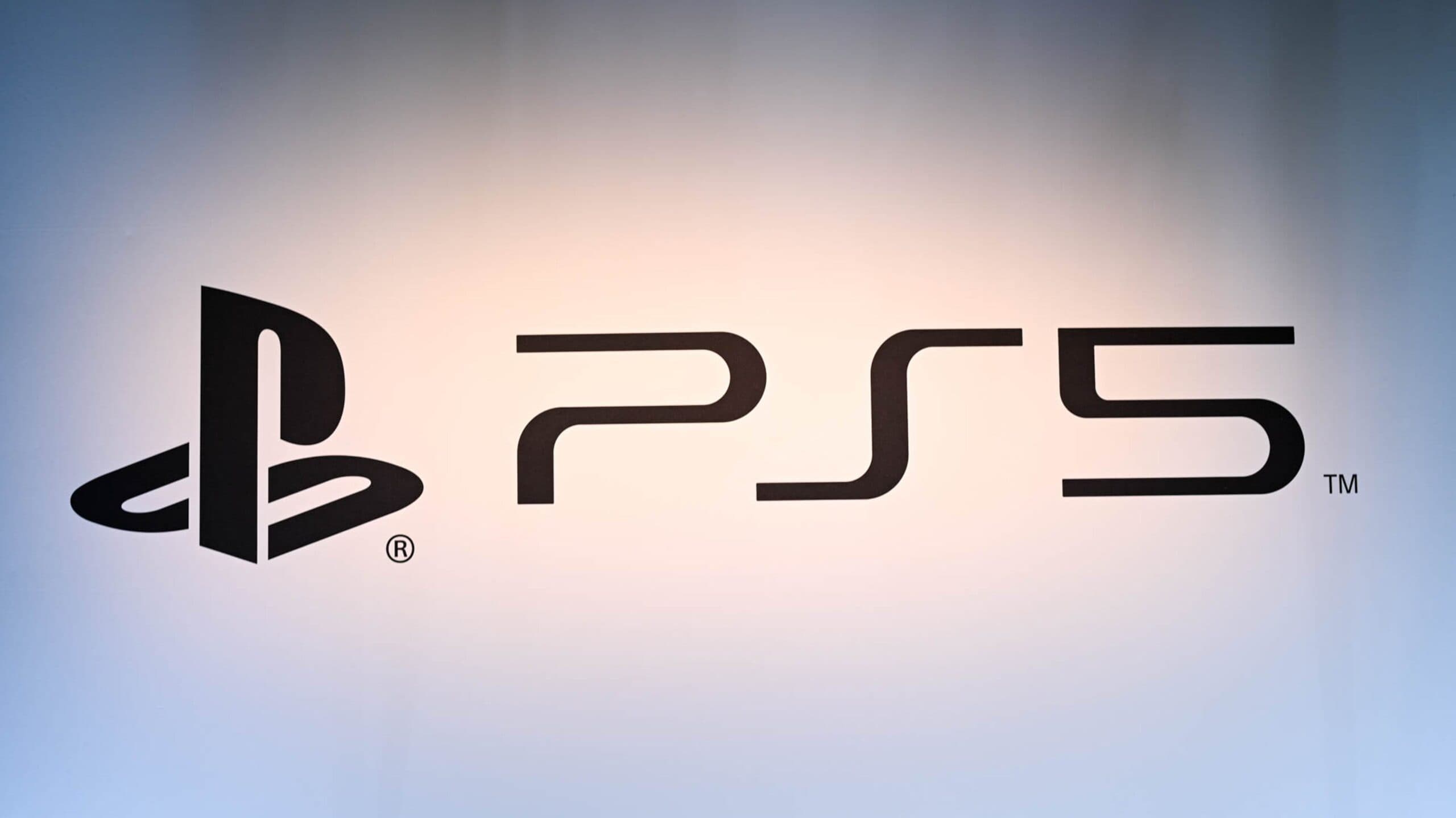 PlayStation 5 console standing vertically with visible ventilation slots on a desk